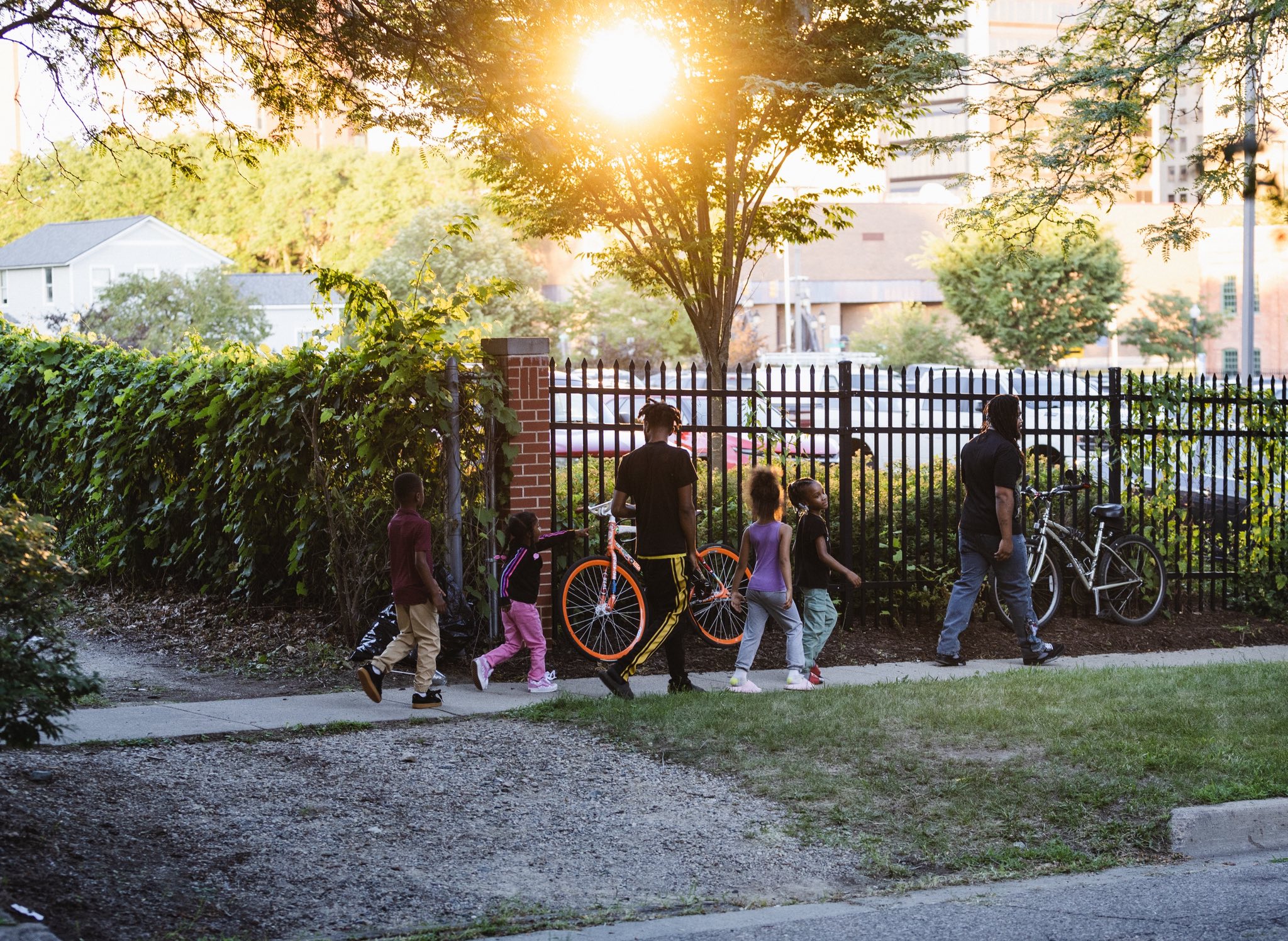 Family walking through the neighborhood at golden hour